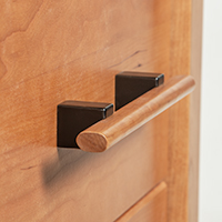 Detailed close-up image of a solid wood drawer pull.