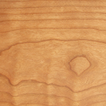 Detailed view of a natural cherry wood surface, showcasing the natural patterns and characteristics of the natural material.