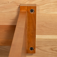 Detailed view of leg construction detail on the bottom of a solid wood console table.