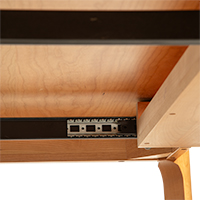 Detailed view of the underside of a soft-close keyboard tray drawer slide and mechanism.