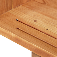 Detailed view of the sliding door construction of a solid wood media console.