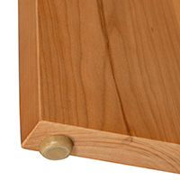 Detailed view of leg construction detail on the bottom of a solid wood console table.