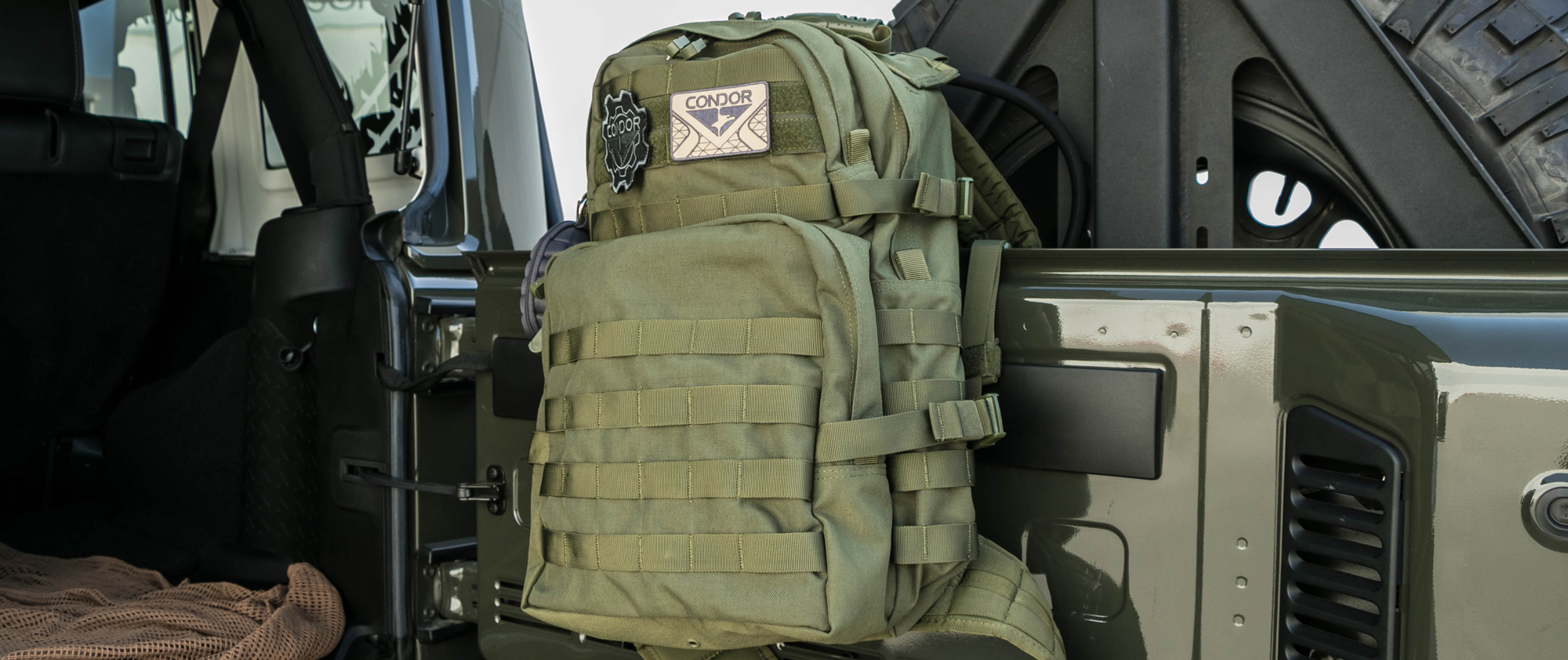 Image of the medium assault pack on the tailgate of a jeep