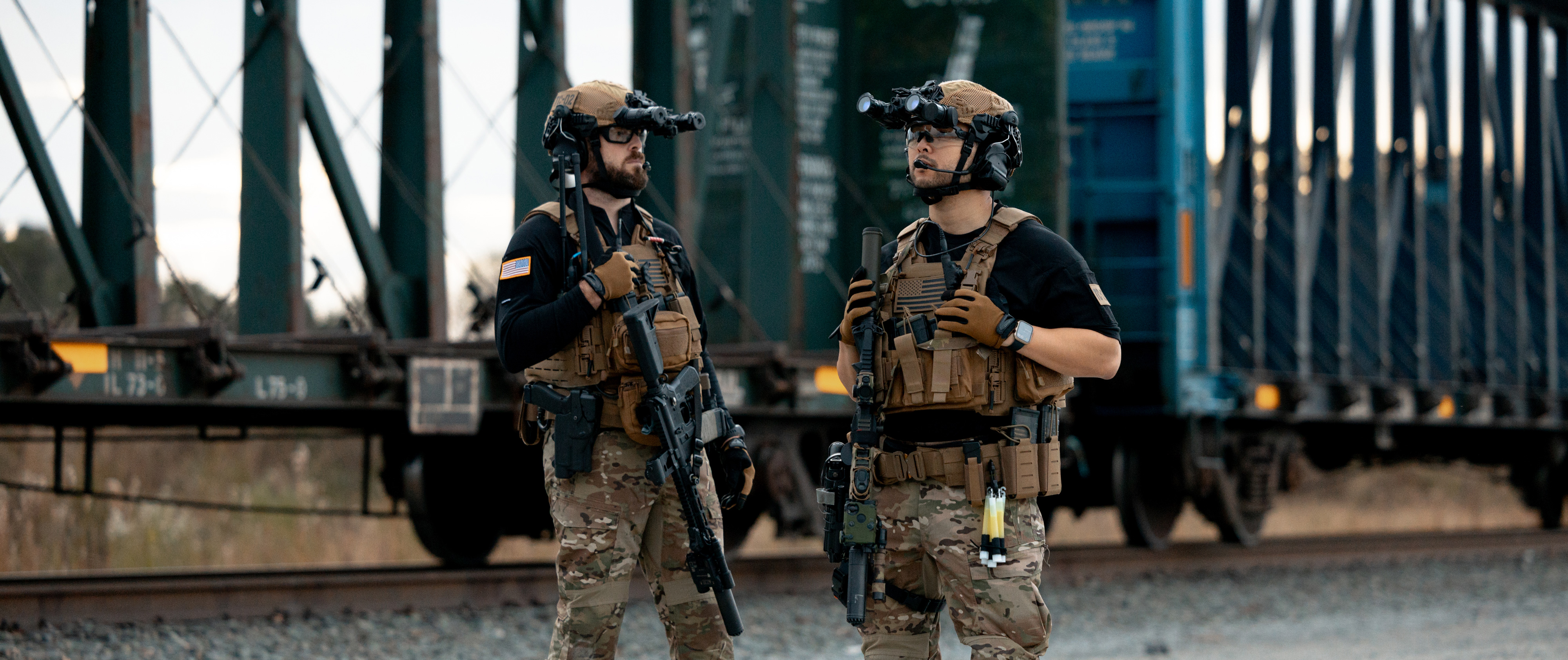 two guys standing around in full kit wearing trident battle tops