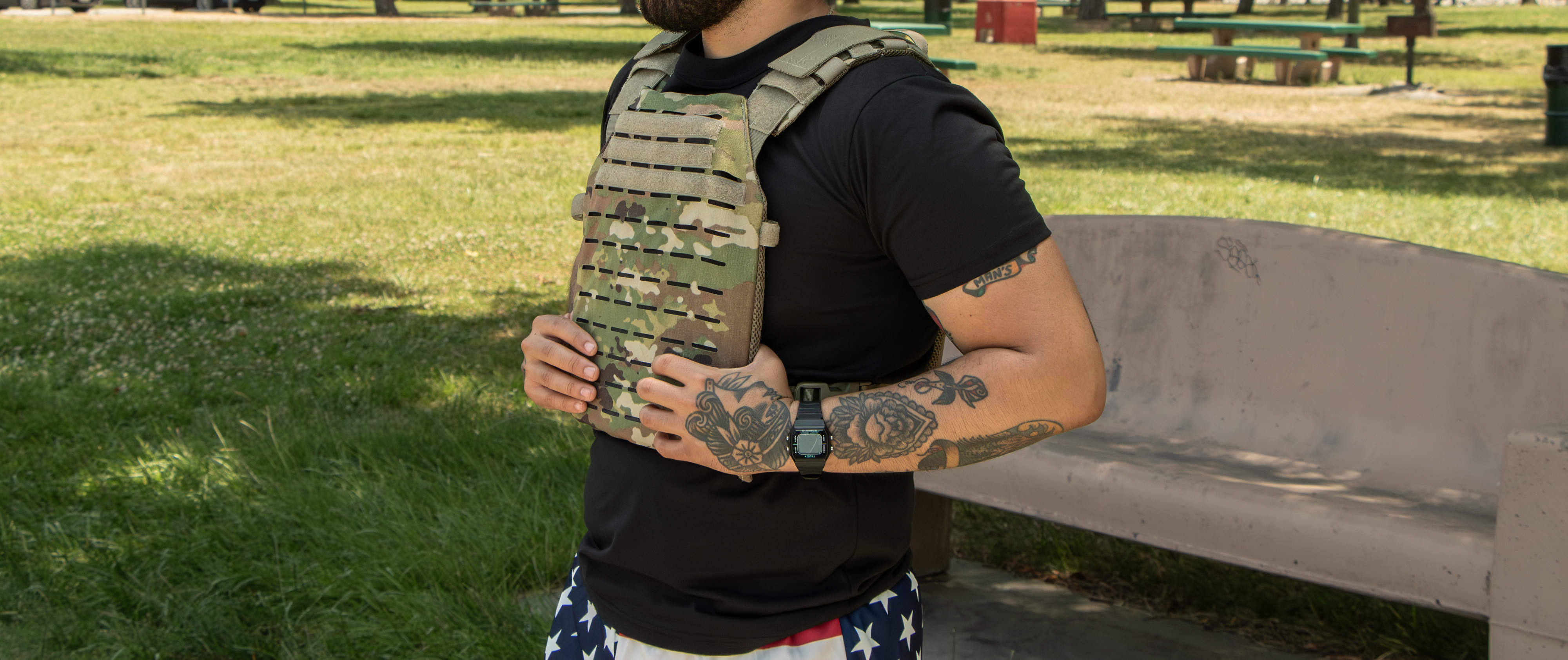 image of a person relxing in a military tee with a plate carrier on top after a workout.