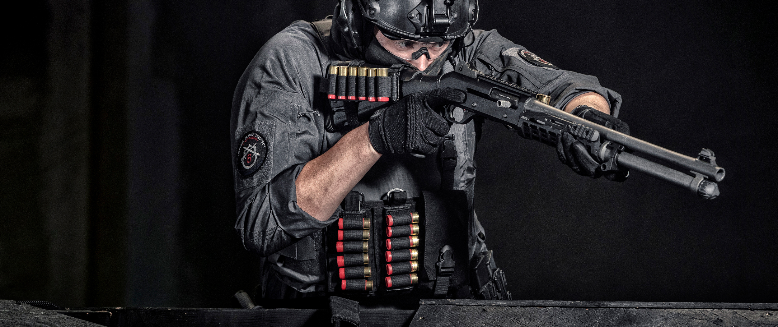 Image of a person with a shotgun using the shotgun shell platform on a vest