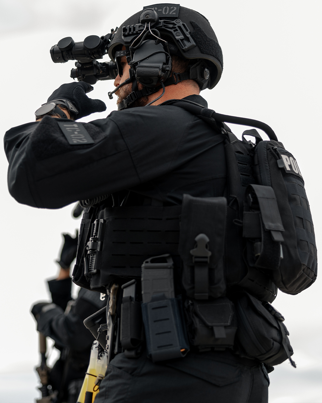 image of a police office wearing a hydration pack where you can see the tube from the bladder.