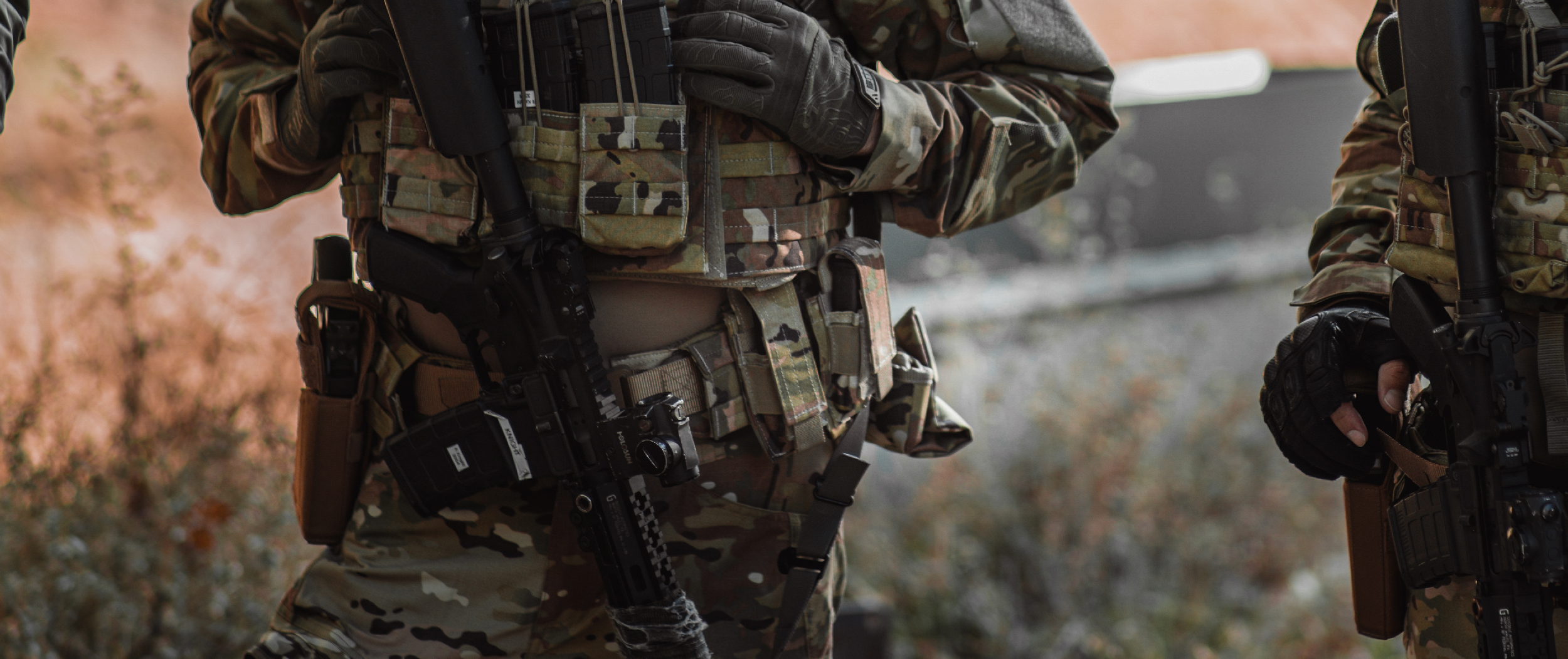 Image of a soldier using a single pistol pouch in multicam