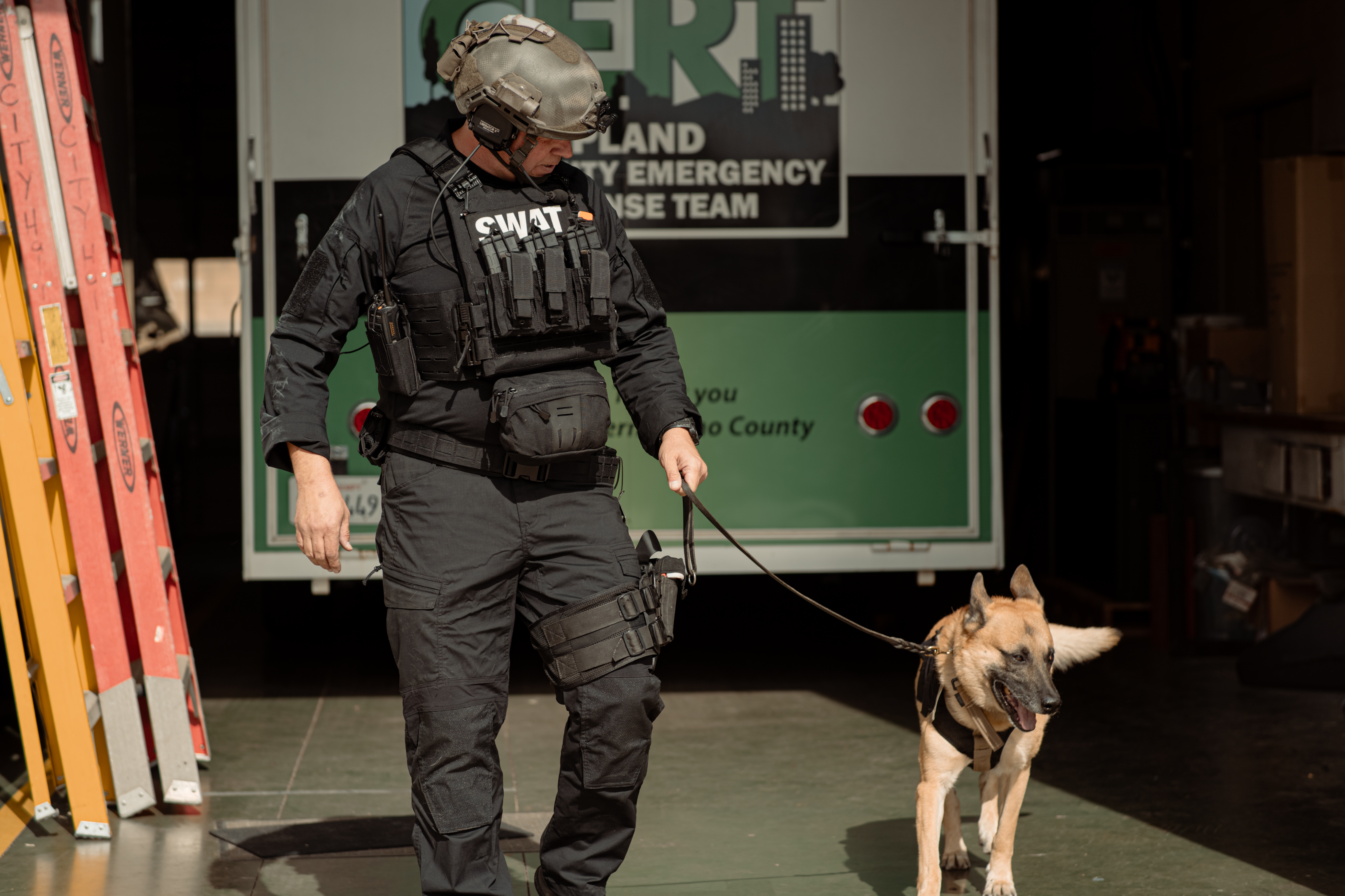 Image of a k9 handler and his dog with the waist pack on his kit 