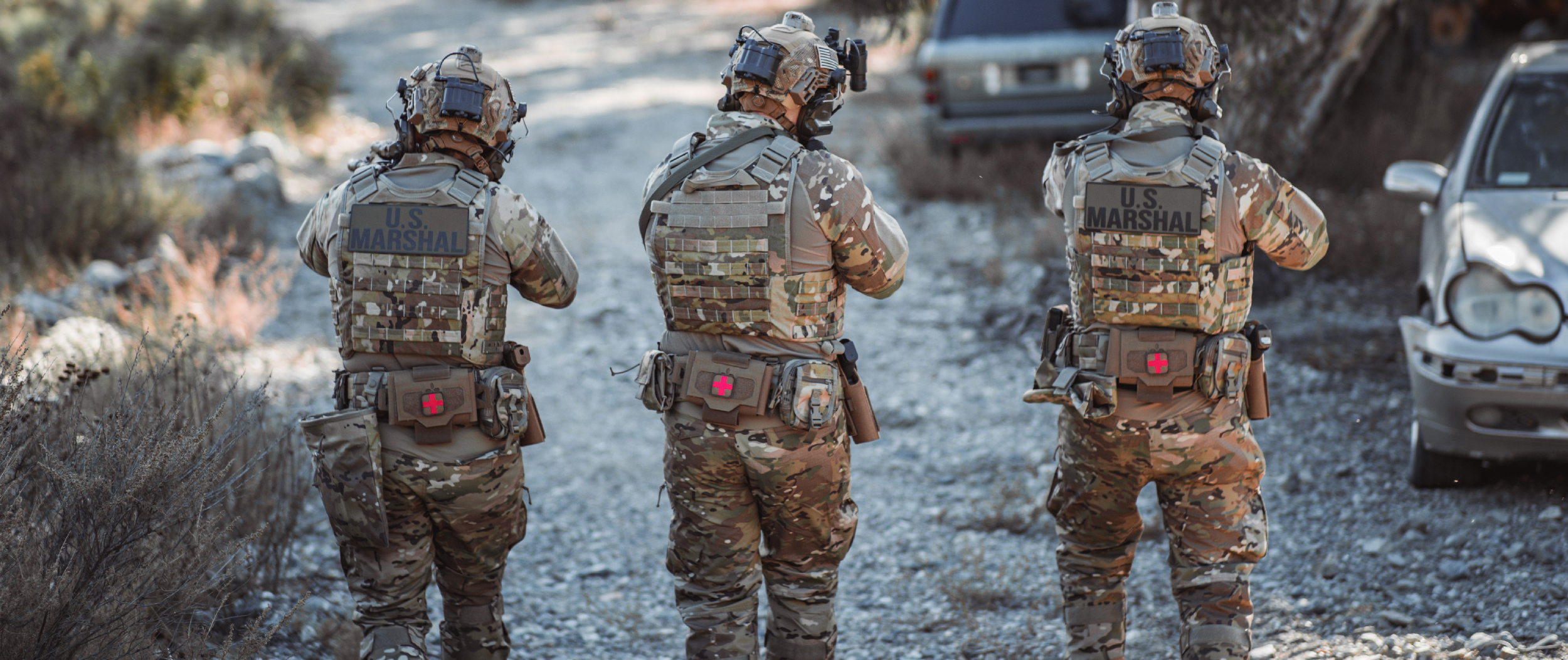 Image of three marshals moving and all of them are wearing slim battle belt setups