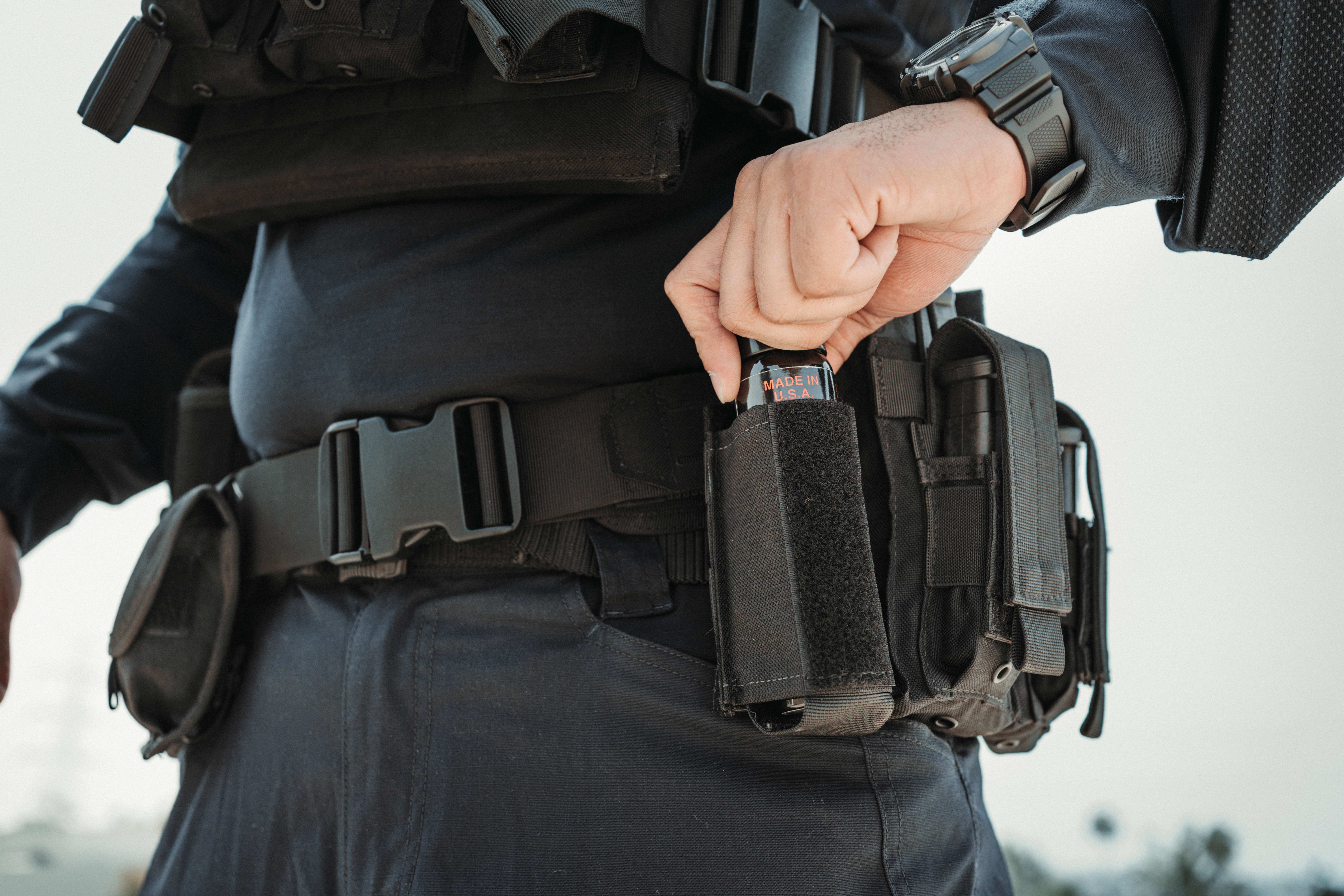 image of a close up of the oc pouch on a police duty belt with oc spray inside