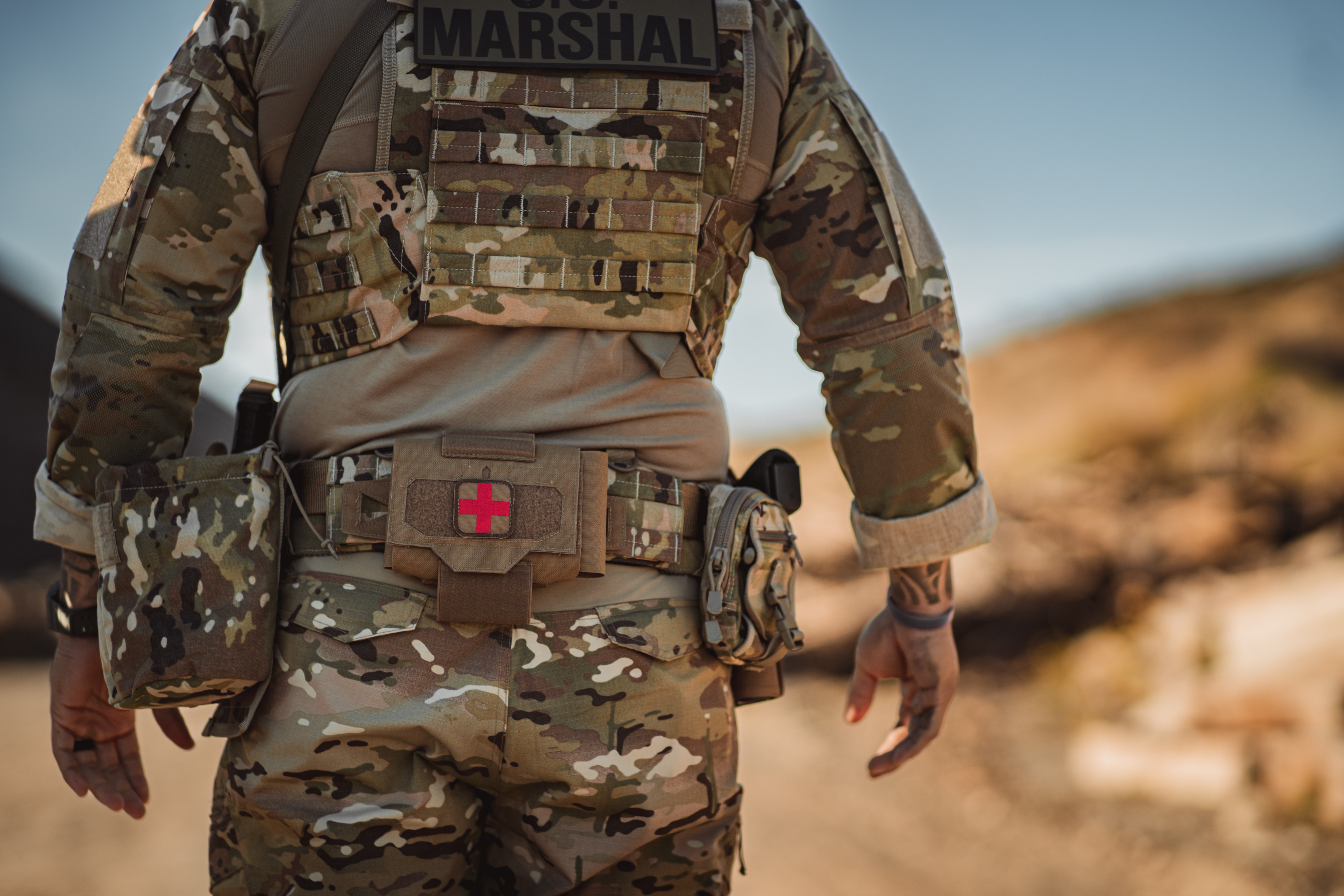 Image of a person wearing a tactical belt that has a utility roll pouch on it