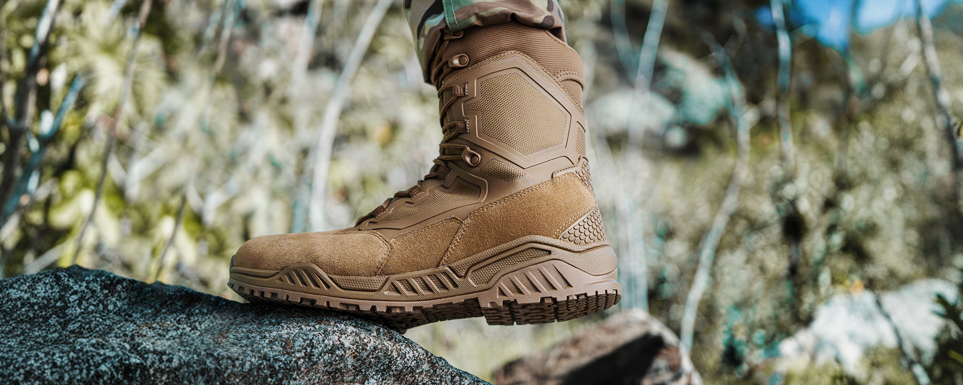 image of someone stepping on a rock with the coyote tan tactical boots