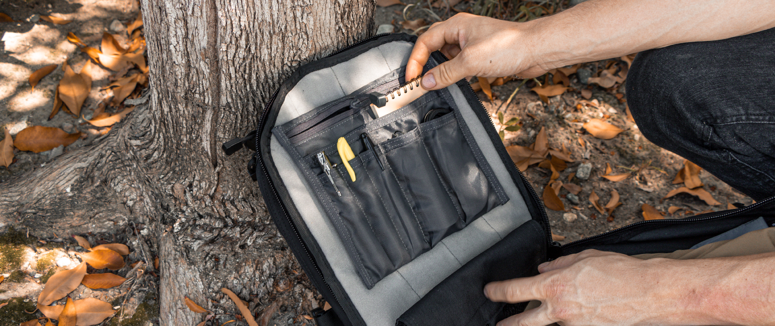 Image of the VA organizer pouch sitting inside of a backpack