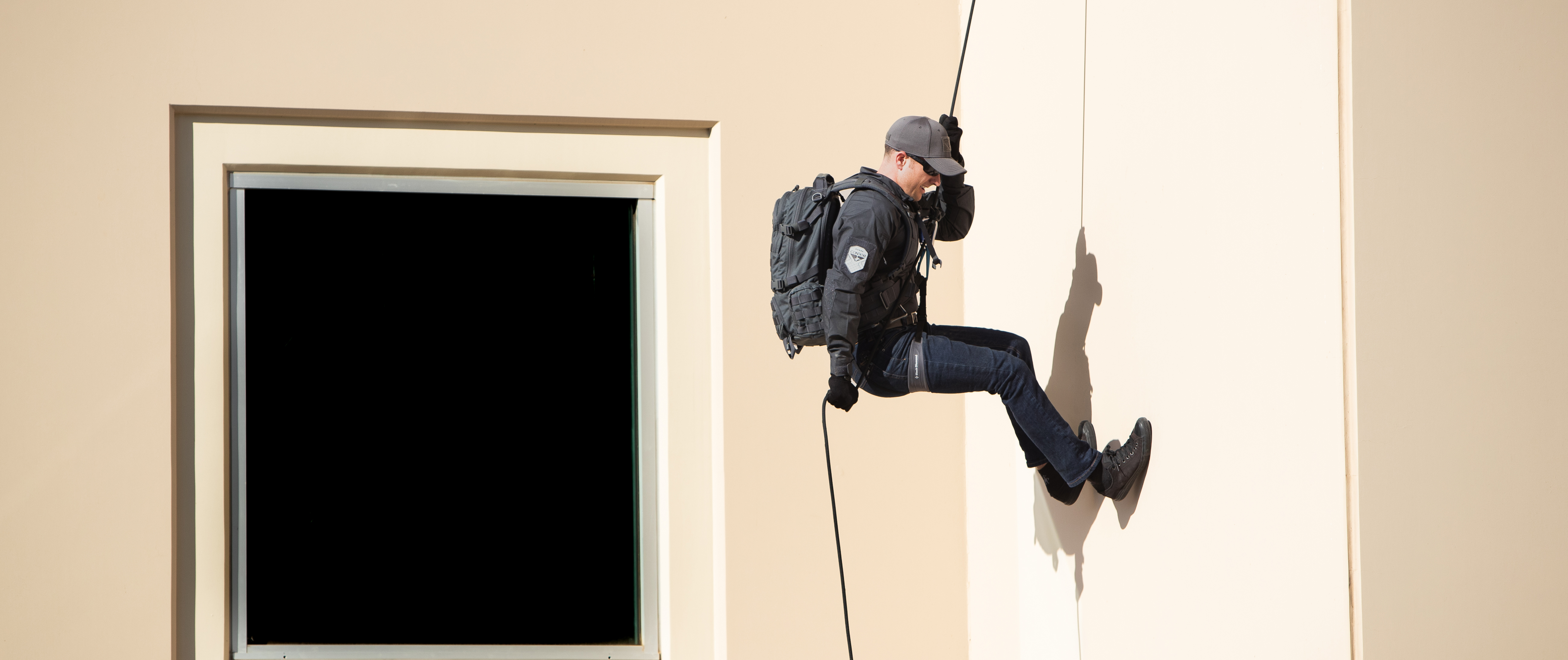 Image of someone rappeling whille wearing Cipher Jeans