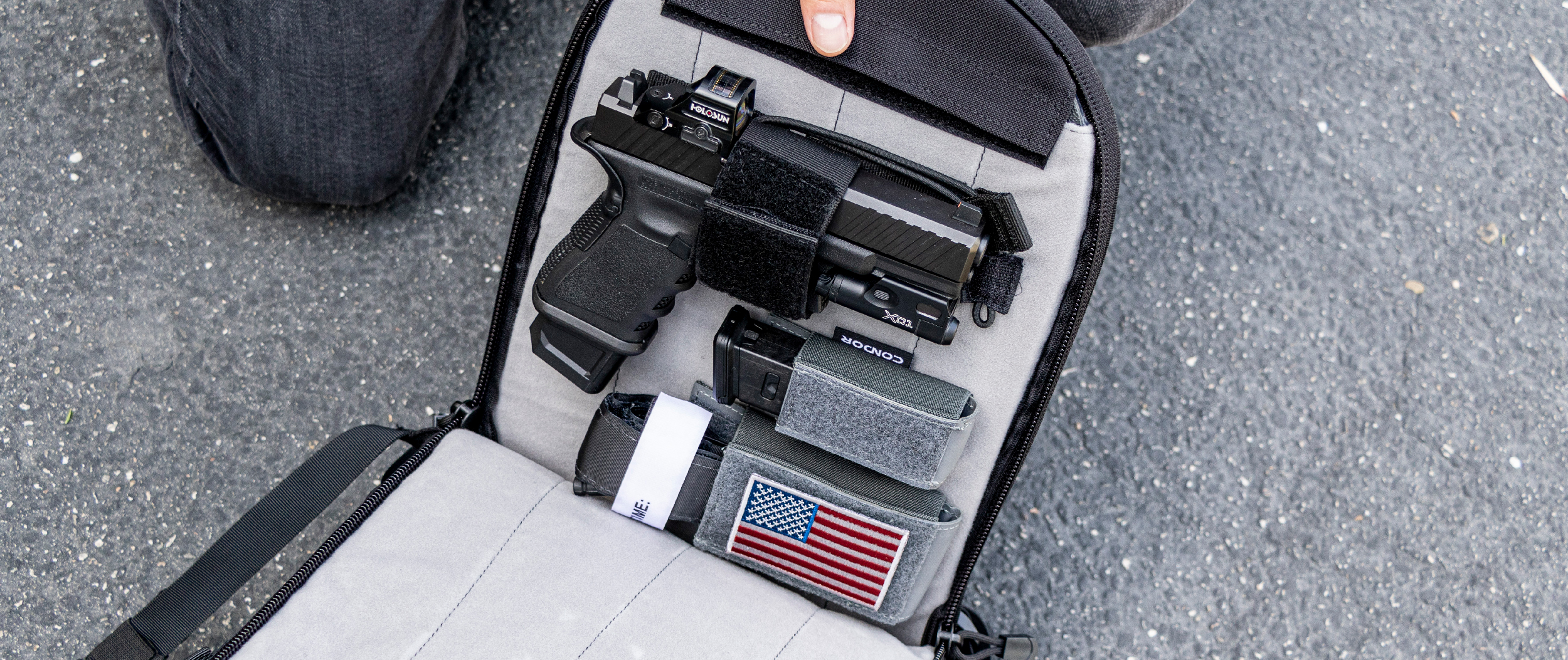 Image of a bag with a universal holster attached for concealed carry