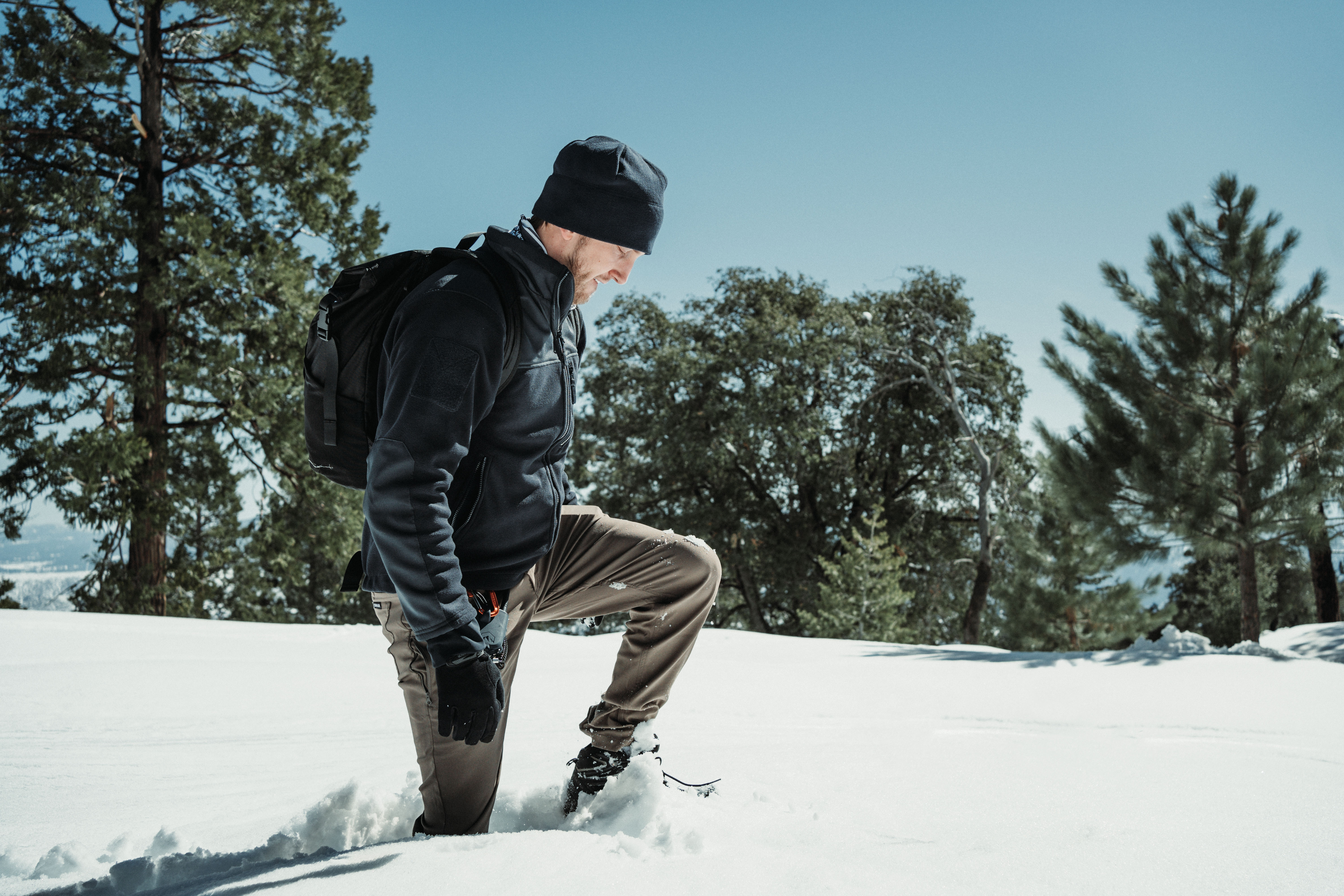 Image of a person walking in the snow wearing the bravo fleece jacket