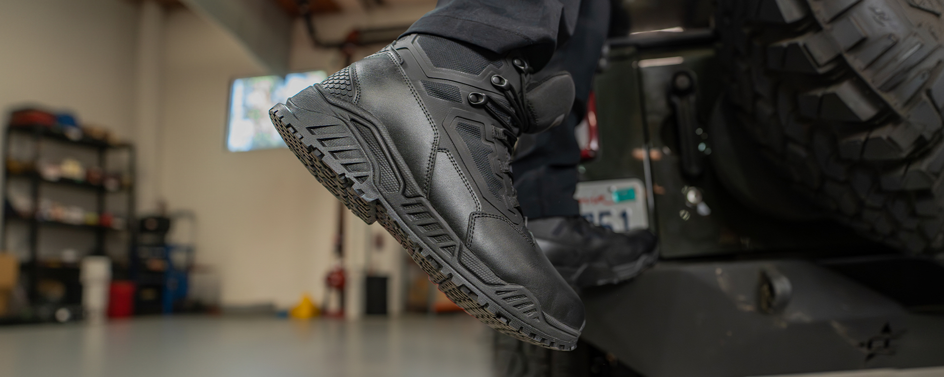 image of someone standing on a truck wearing the 6inch tactical boots in black