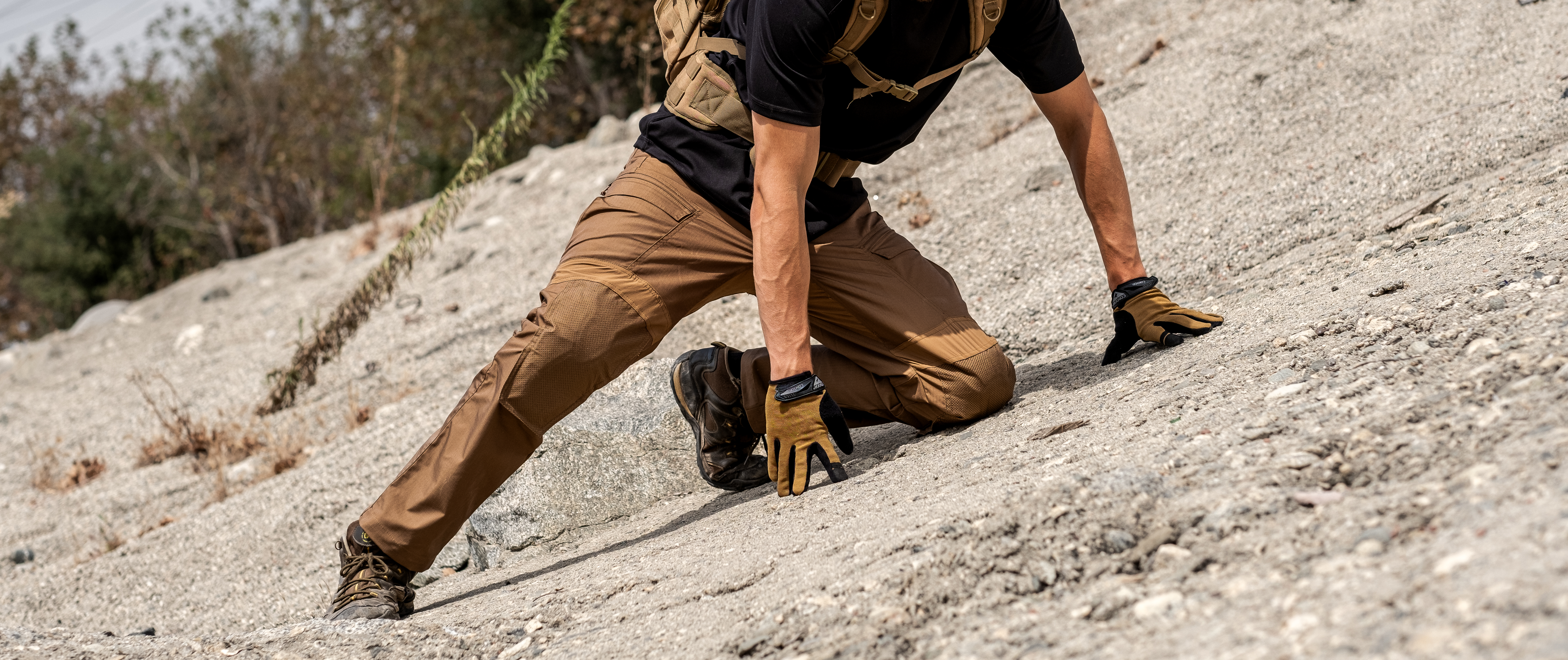 Image of Man Kneeling On A Rock While Using Paladin Combat Pants