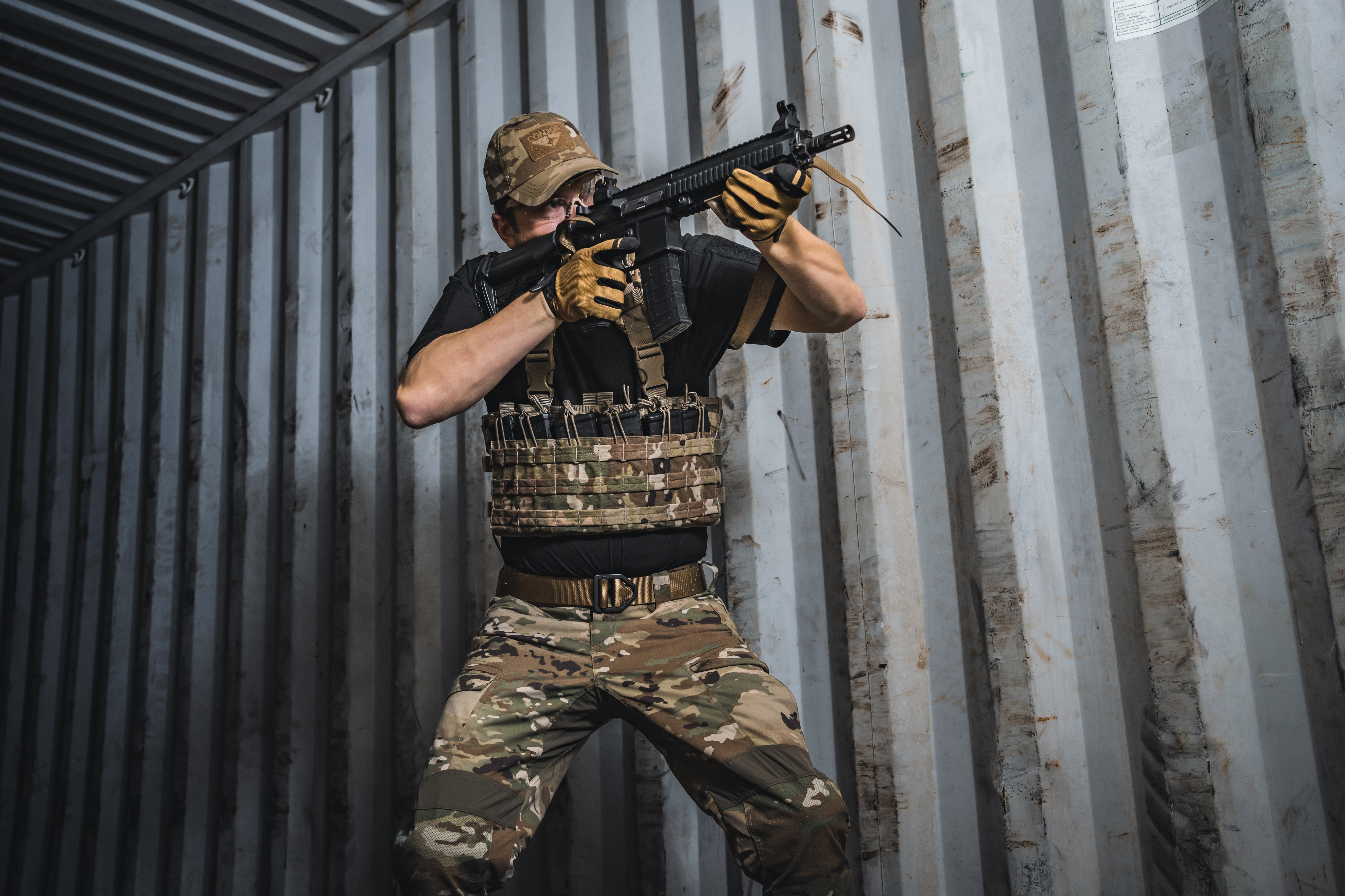 image of a person holding a rifle while wearing a rapid assault chest rig