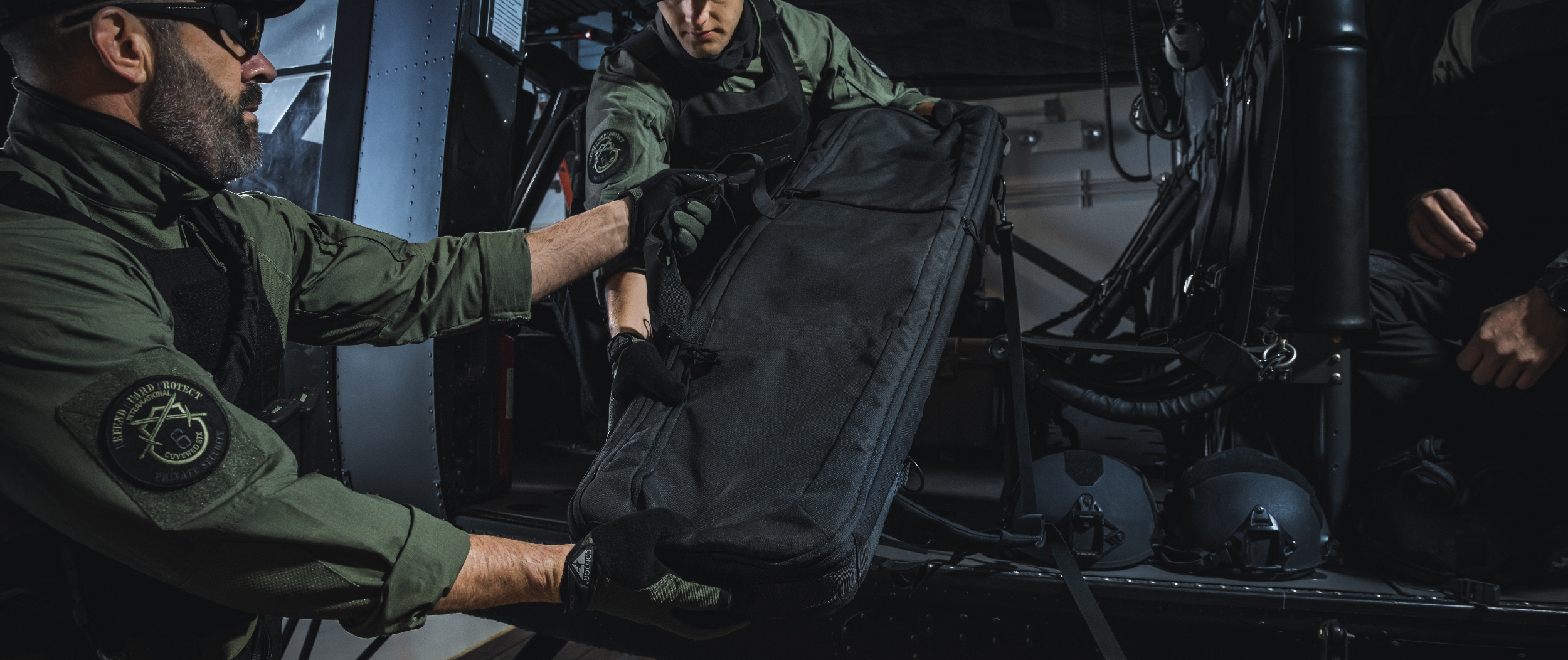 Image of the rifle case being loaded onto a helicopter