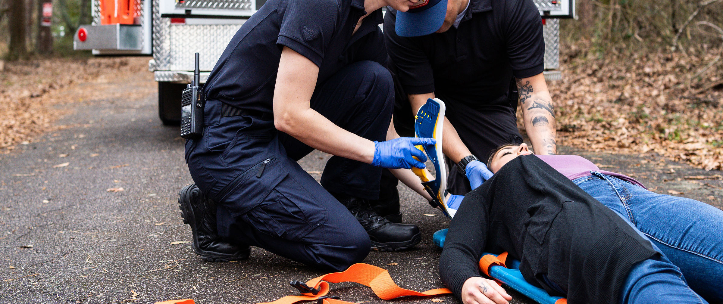 image of an EMT wearing the EMS pants beside a patient