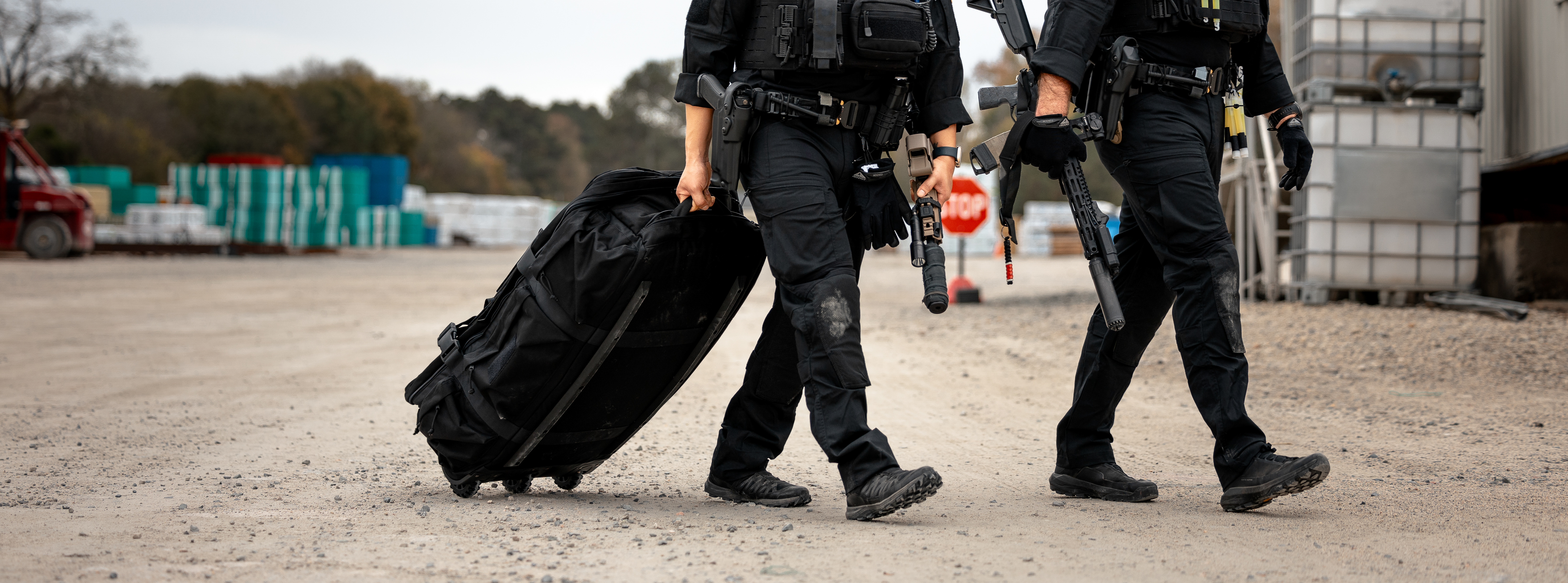 Image of two swat officers rolling the duffle bag