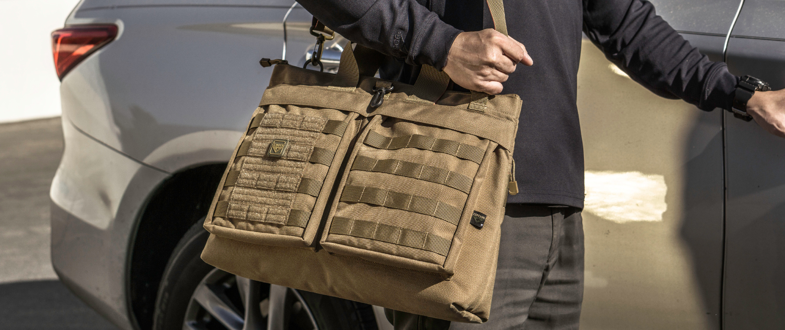 An image of someone carrying an aviator bag on their shoulder