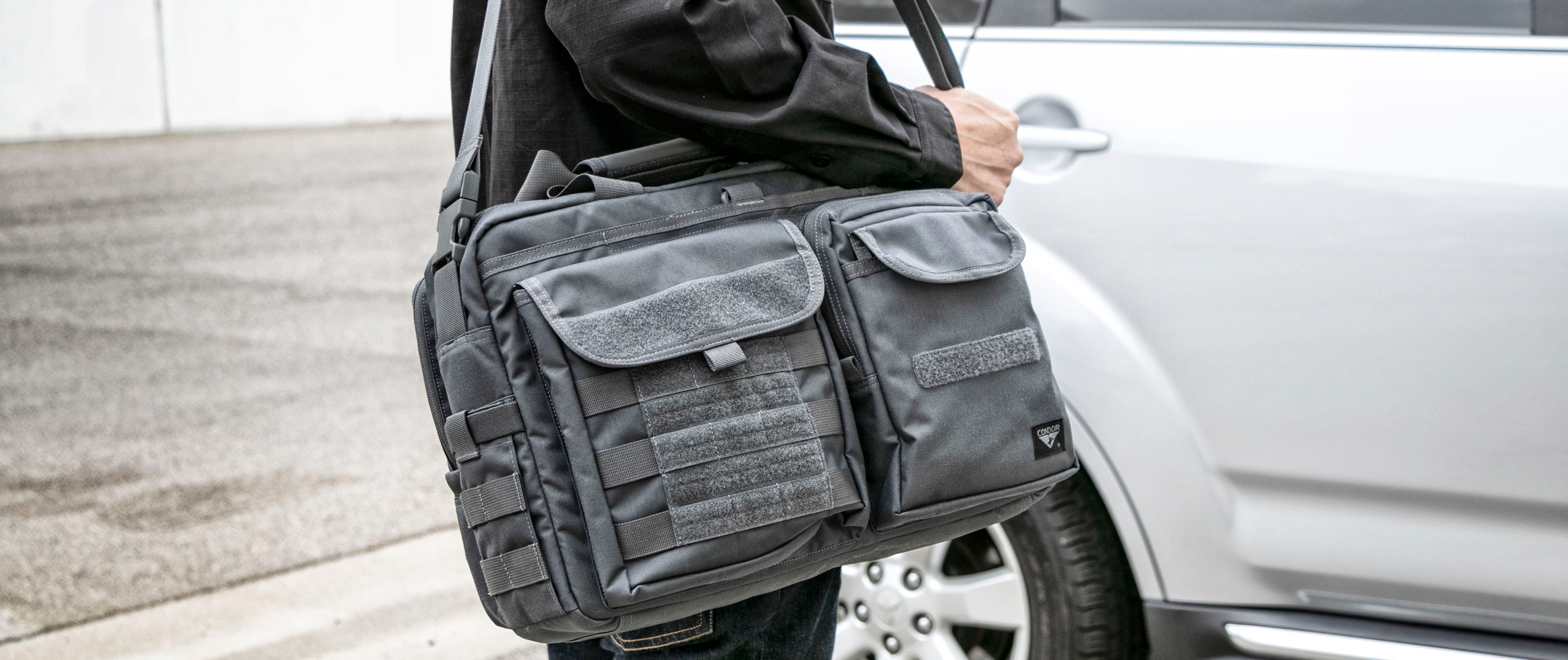 Image of someone near their car wearing the tactical briefcase