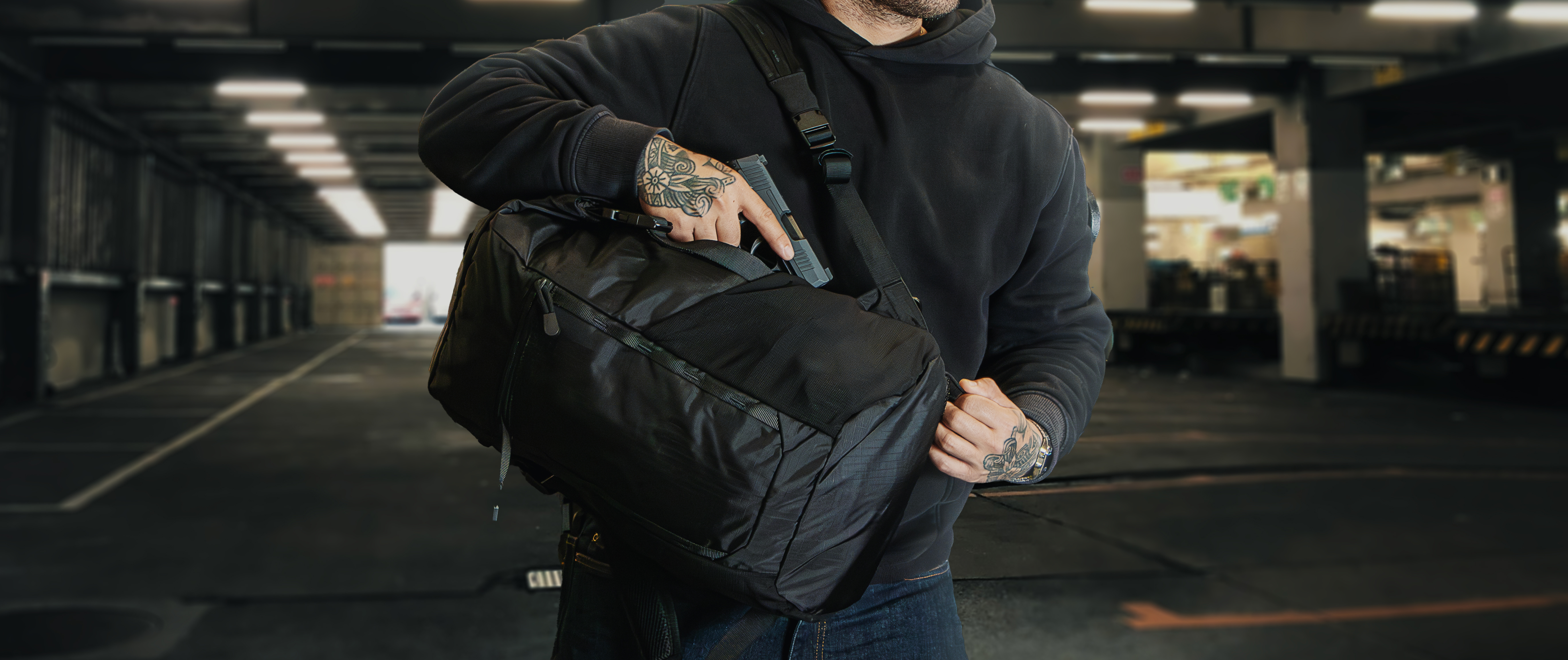 Image of someone pulling out a concealed pistol from the bag