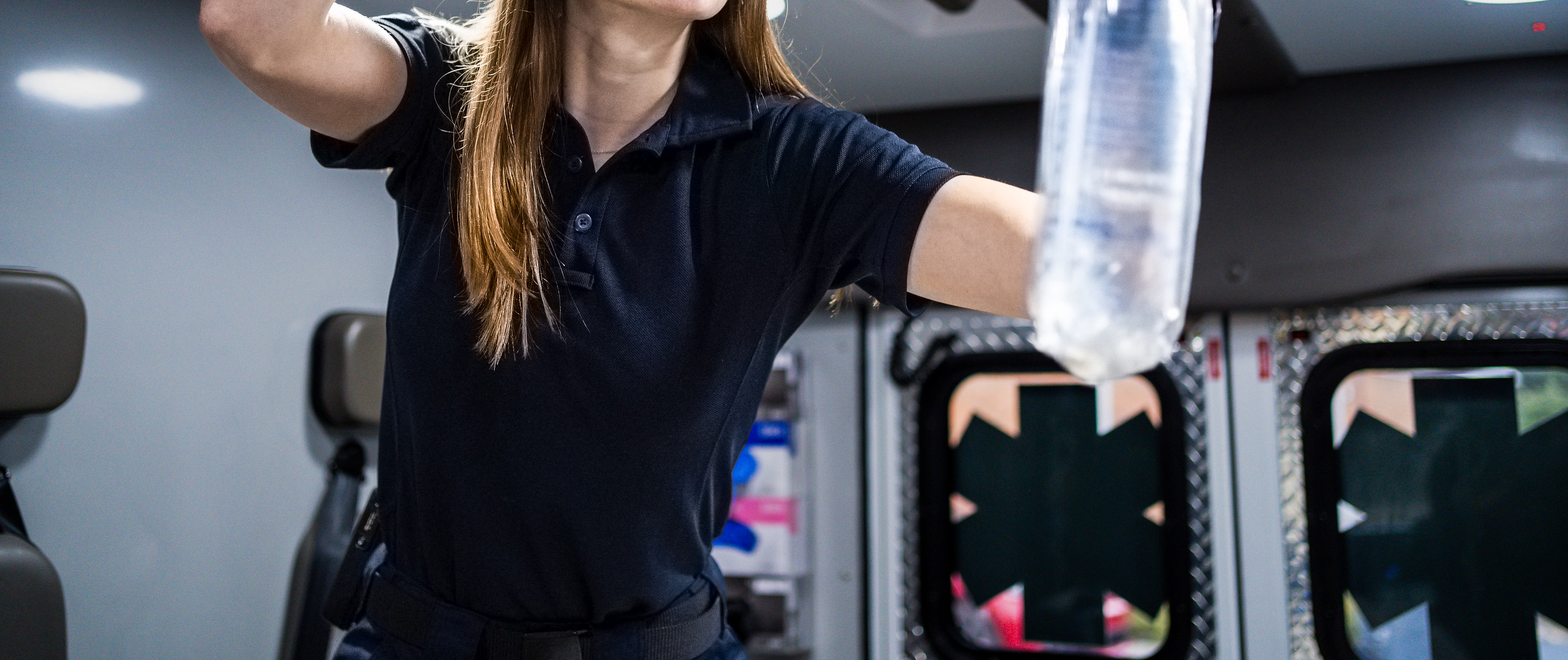 close up image of the womens tactical polo shirt inside of the ambulance
