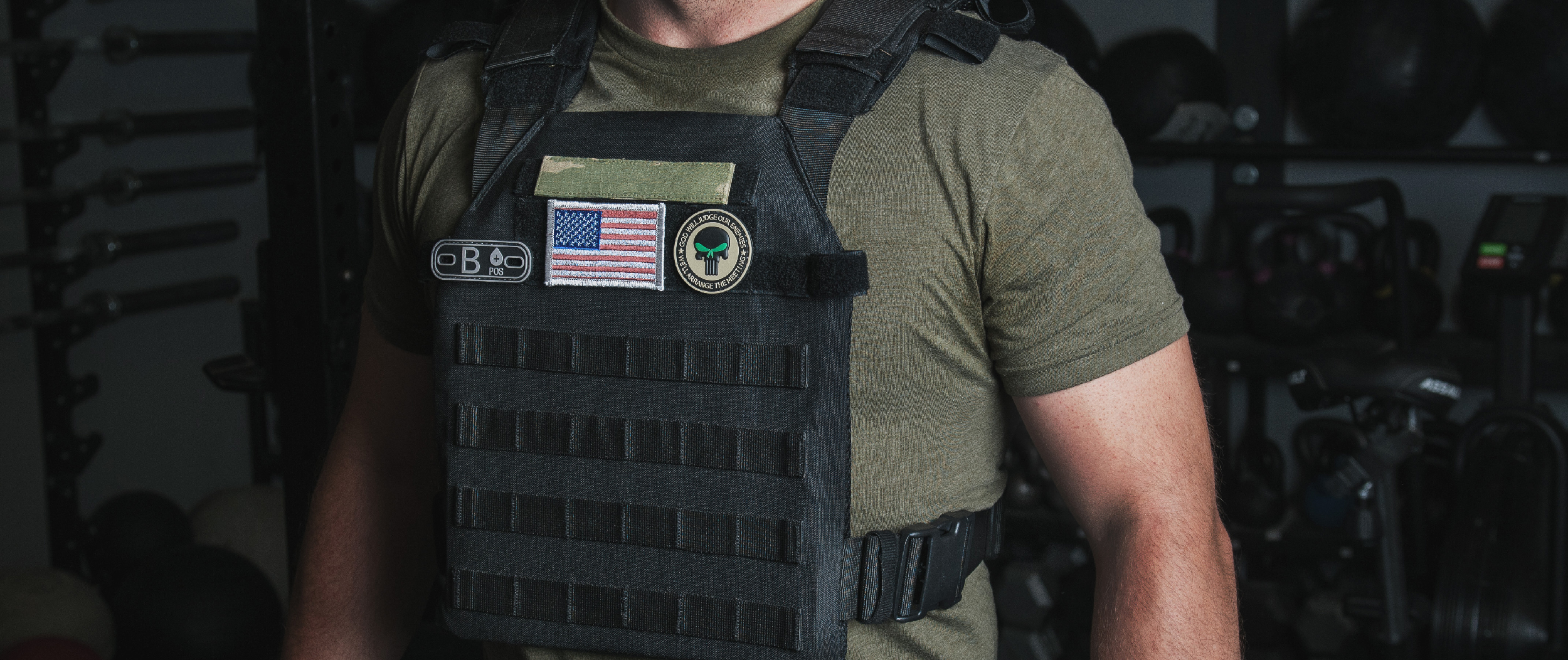 Image of a black sentry plate carrier being used at the gym