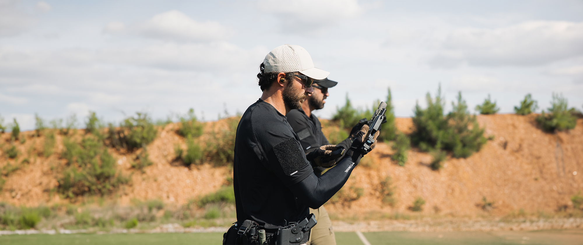 Image of someone shooting at the range in arm sleeves
