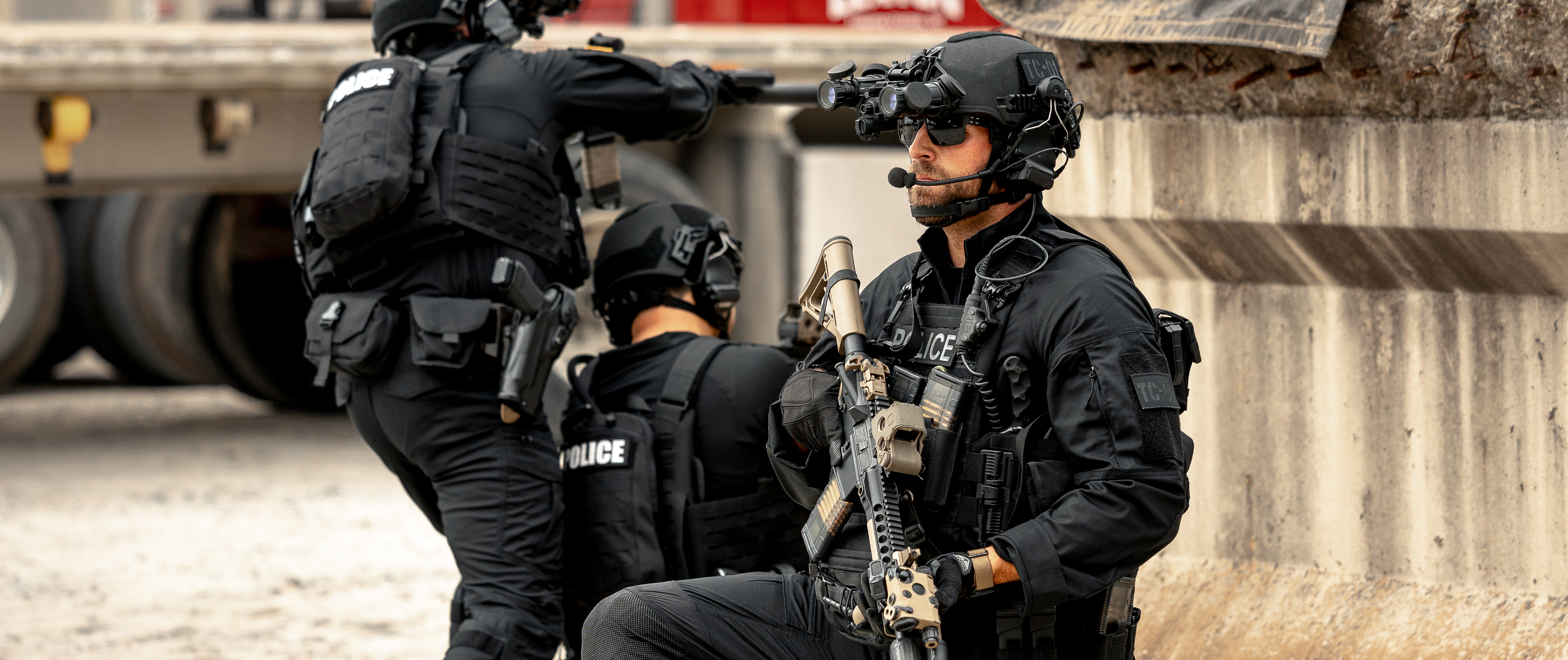 Image of three officers kneeling in full kit while wearing long sleeve combat shirts