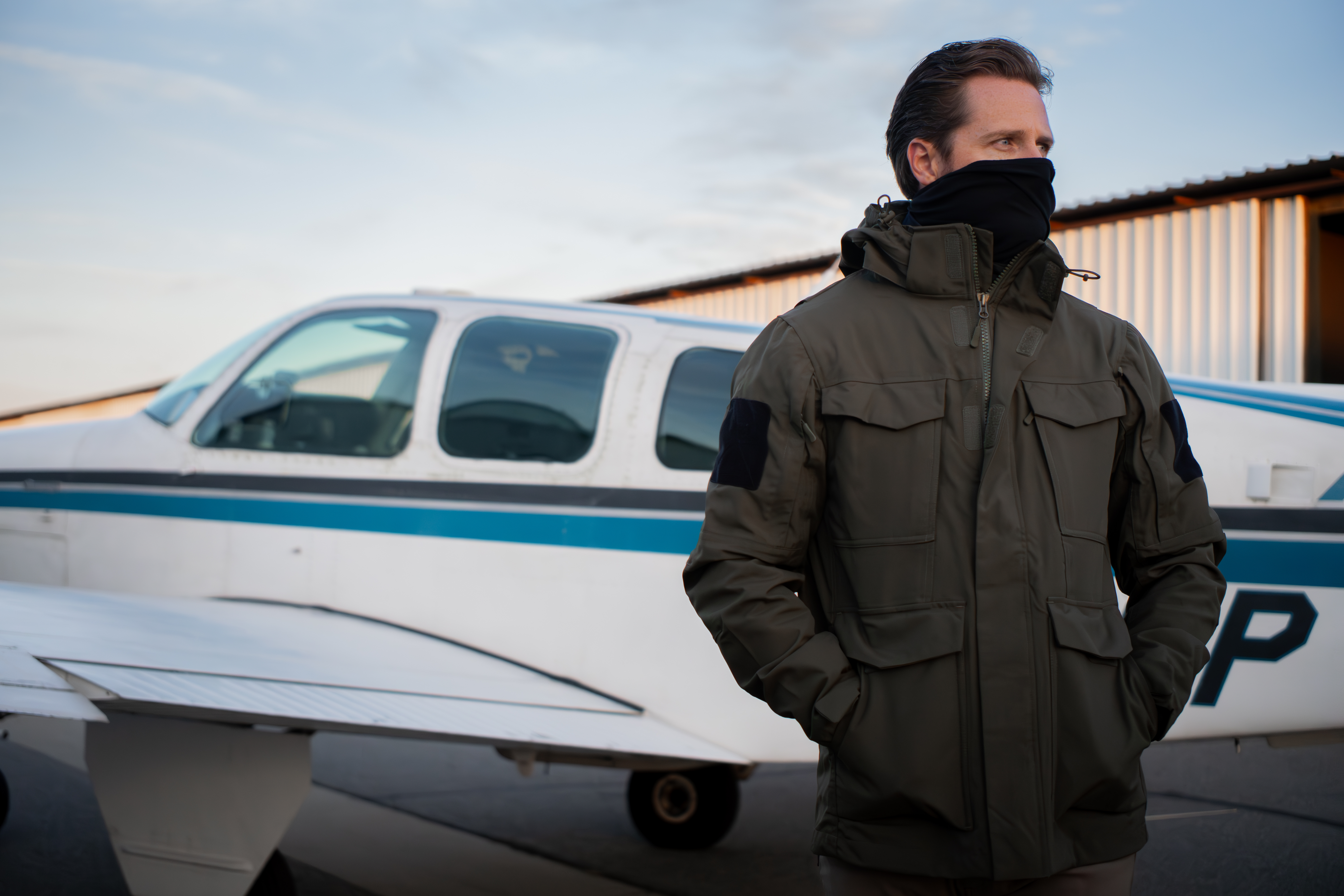a cold image of a person in the waterproof parka with a facemask on
