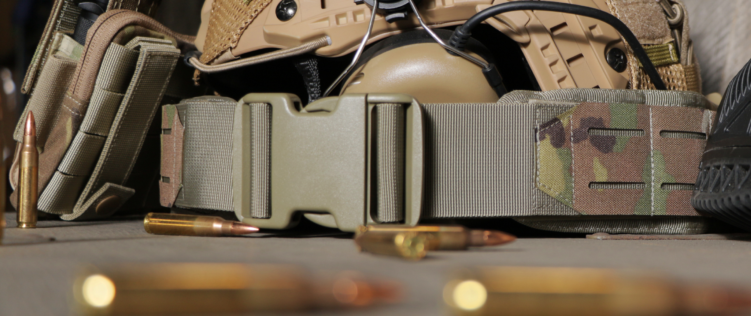 image of a multicam lcs gun belt on a table with tactical gear around it
