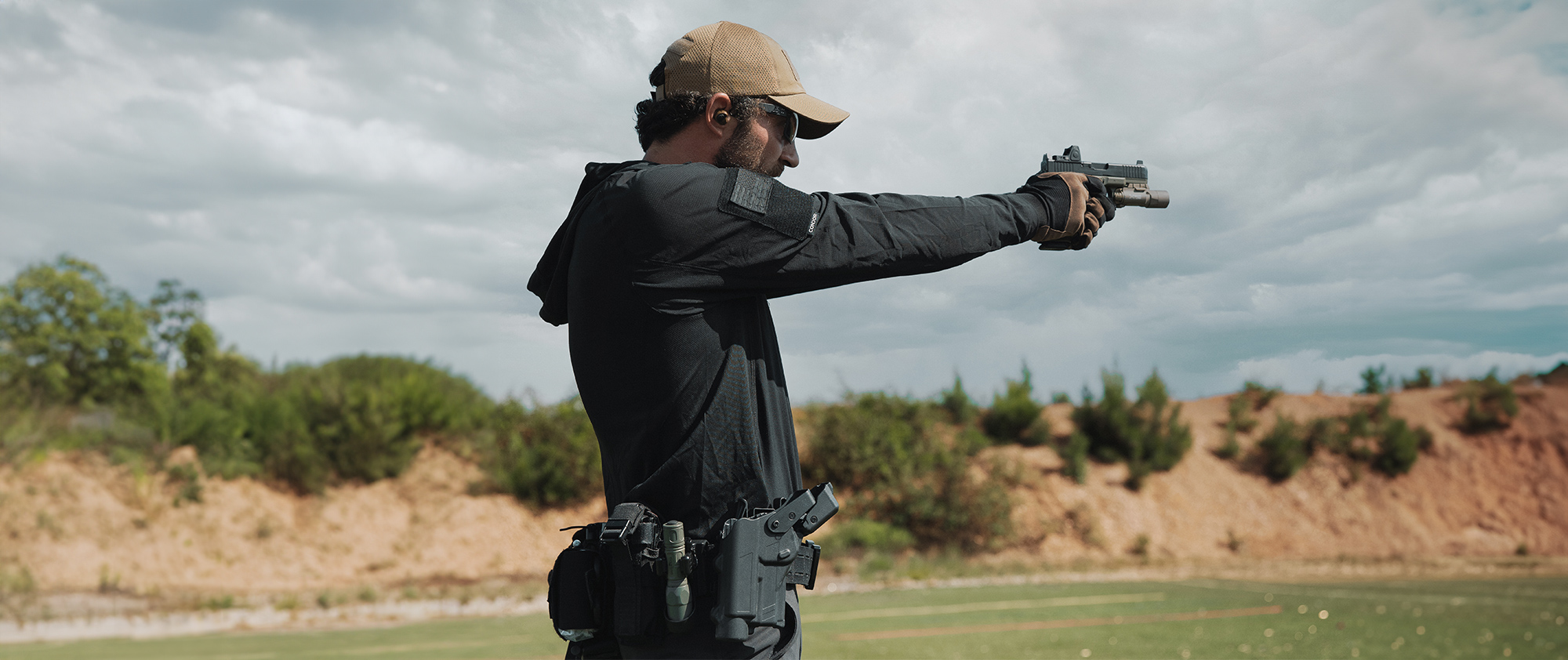 Image of someone at the range adjusting targets with the hood up on their tactical sun shirt