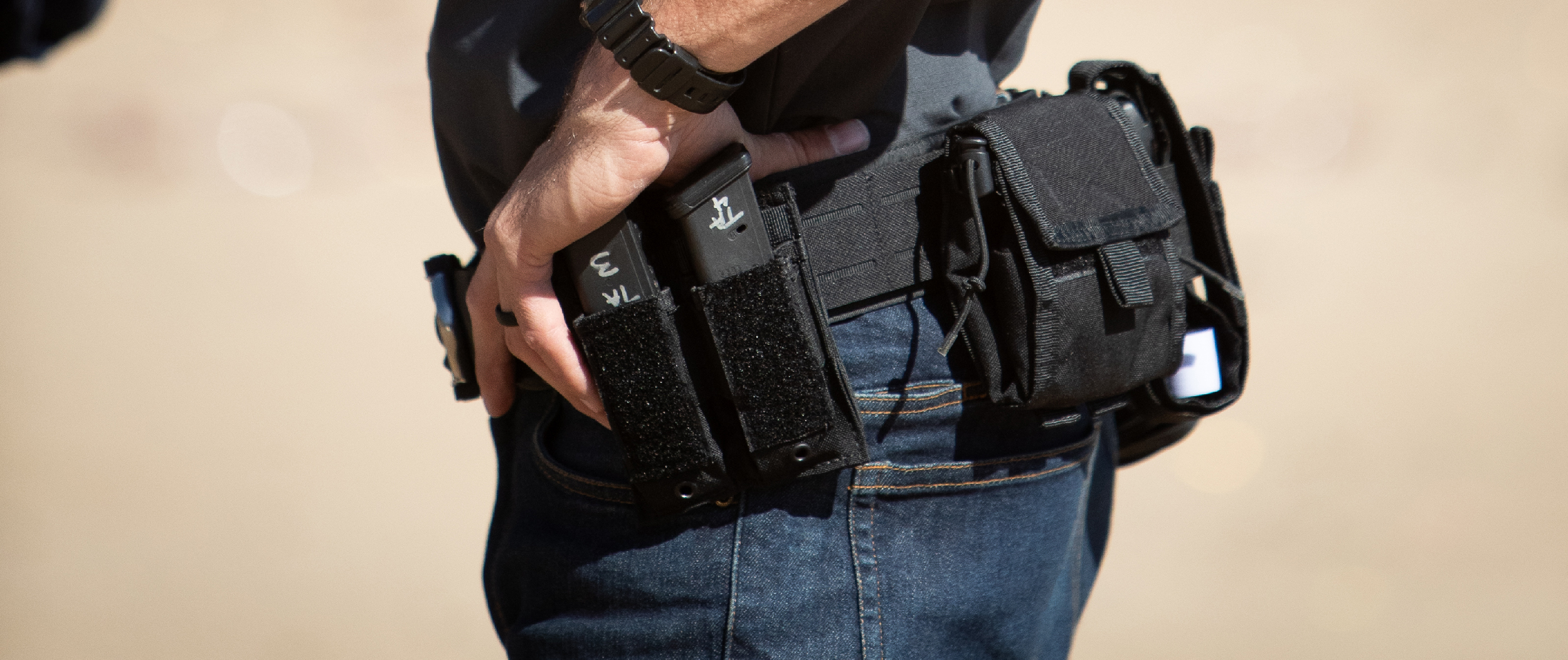 Image of a close up duty belt where the focal point is the double pistol mag pouch