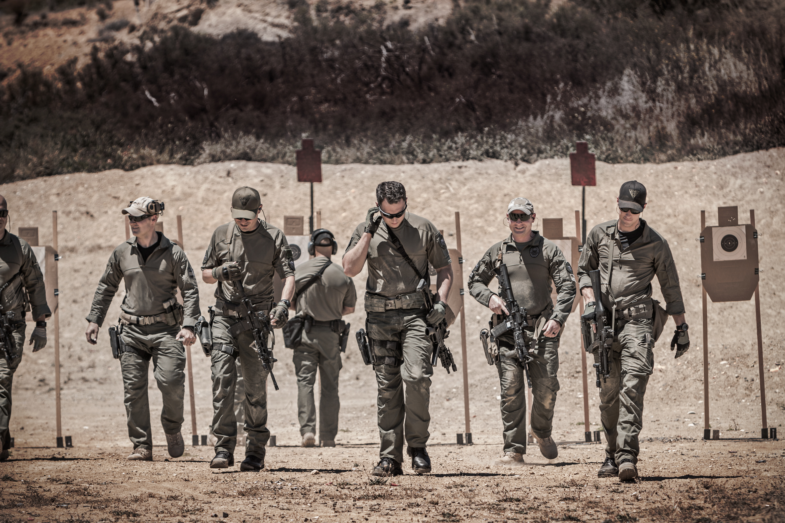 Image of swat members at a range wearing battle belts