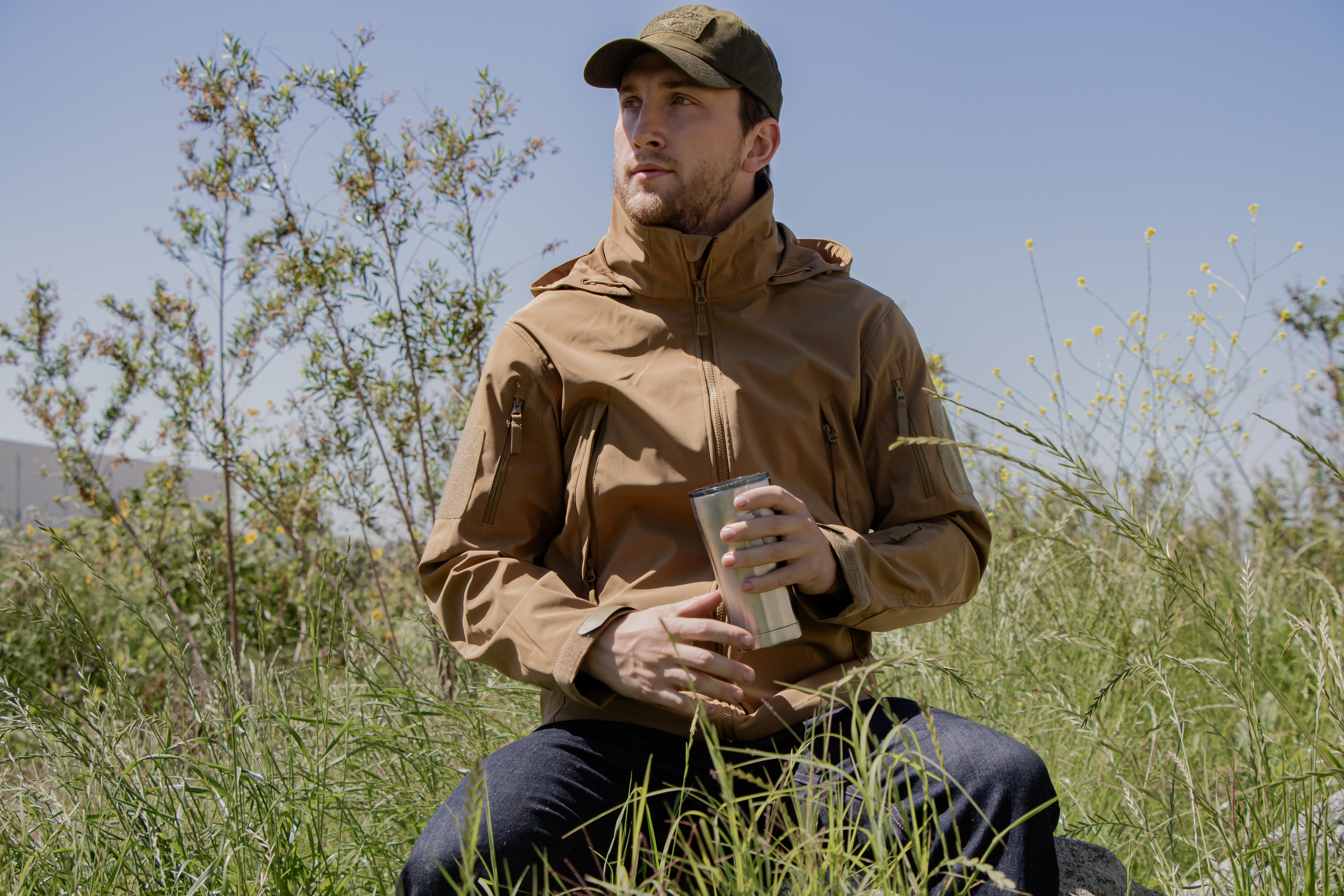 Image of a man looking for something on an offroad vehicle wearing the summit zero