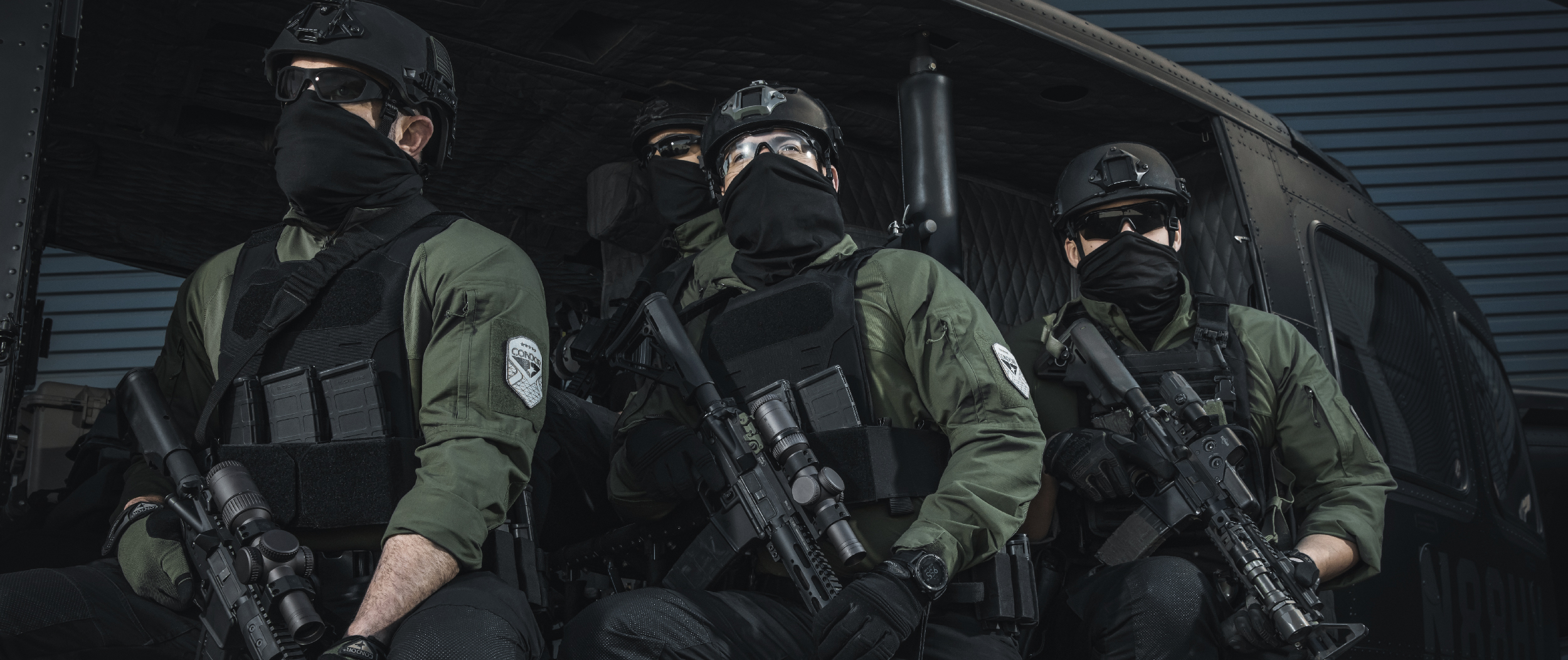 Image of guys in a helo using the specter with the kangaroo pouch