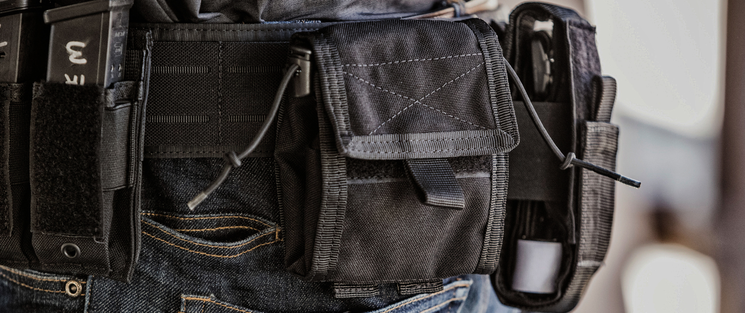 Image of a person wearing a tactical belt that has a utility roll pouch on it