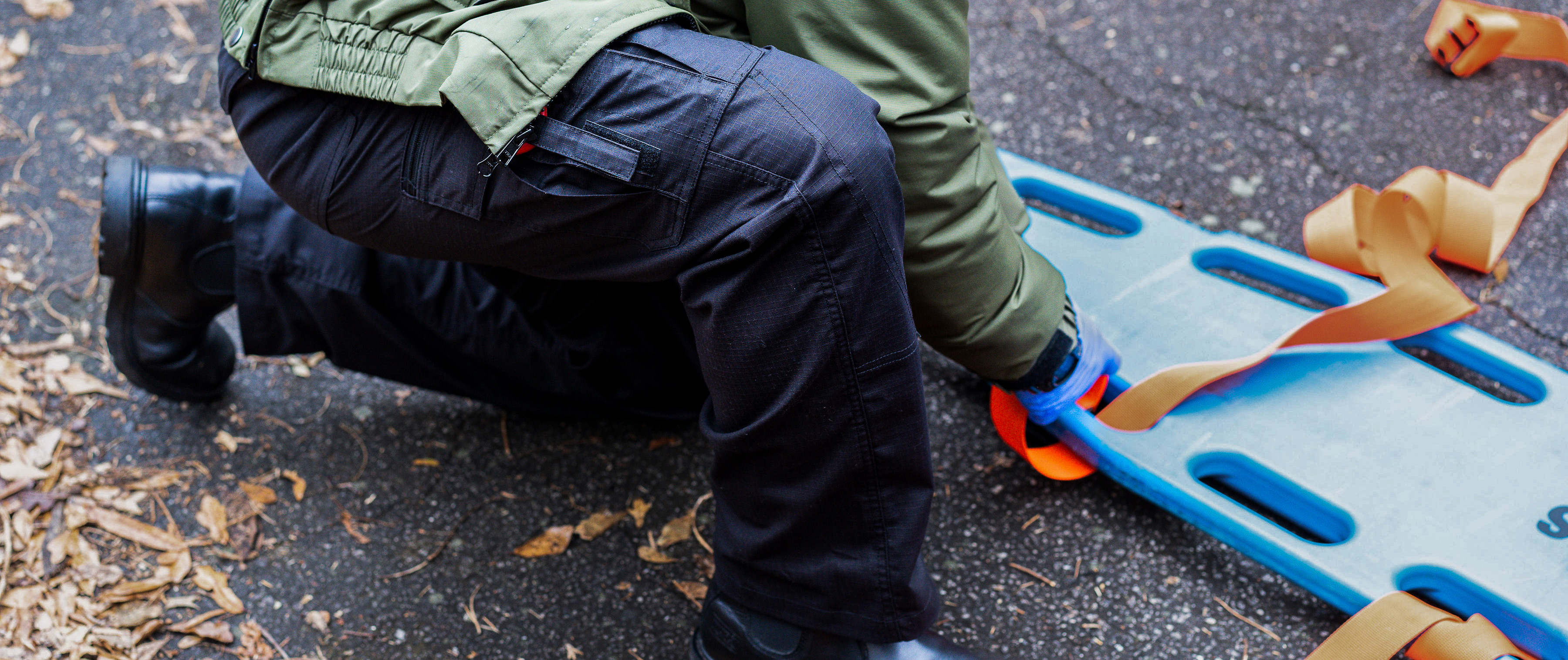 man getting a stretcher ready while wearing condor ems pants