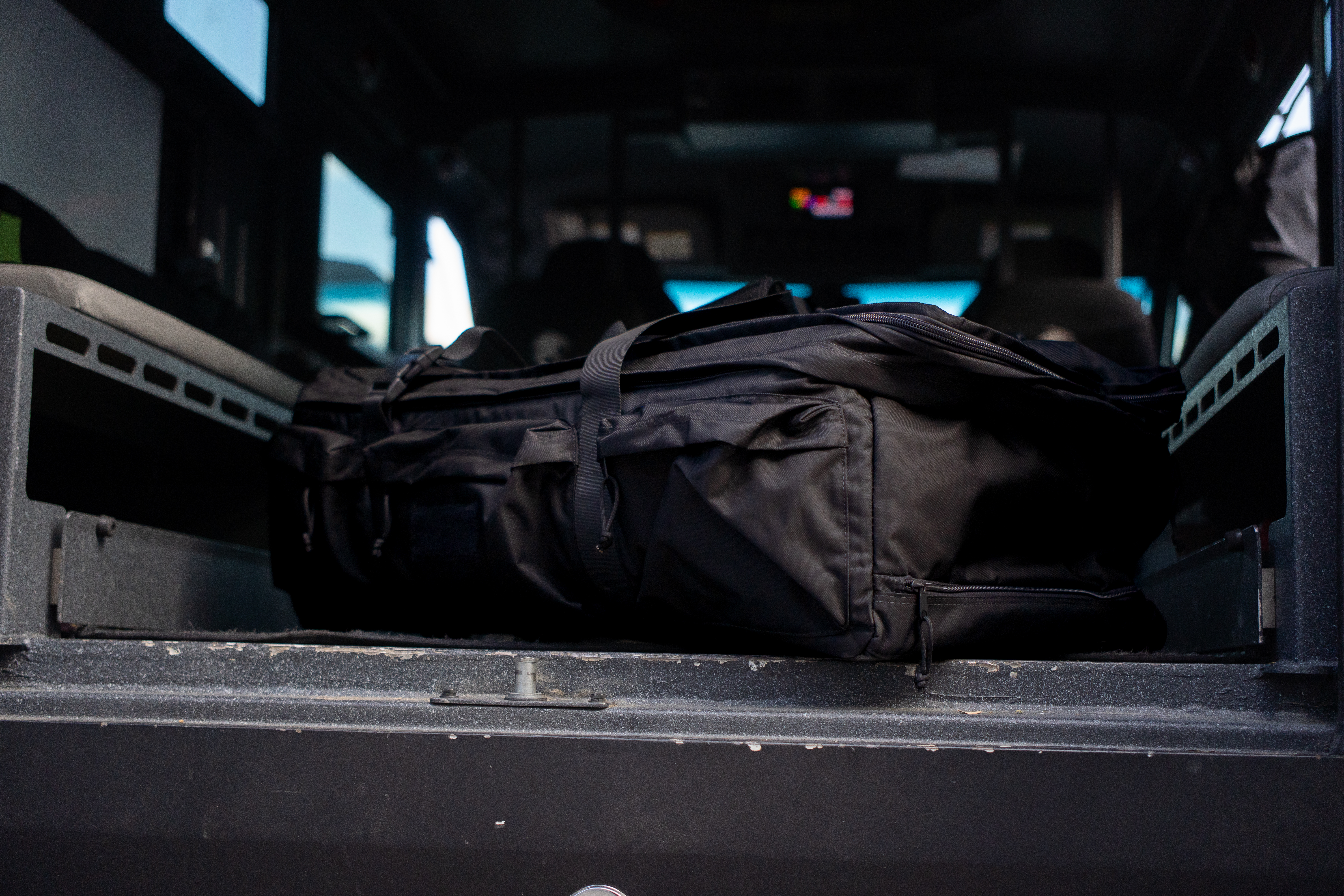 Image of a person rolling an expanded duffel near an airplane