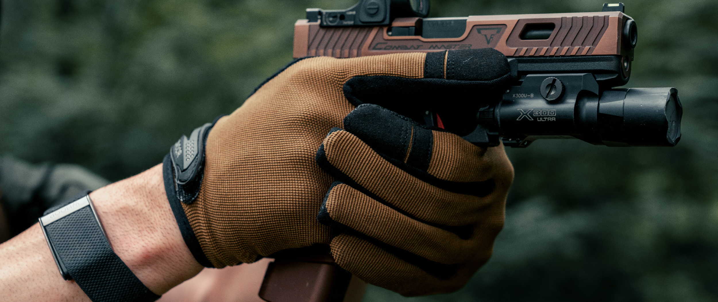 Image of someone wearing shooter gloves shooting a pistol