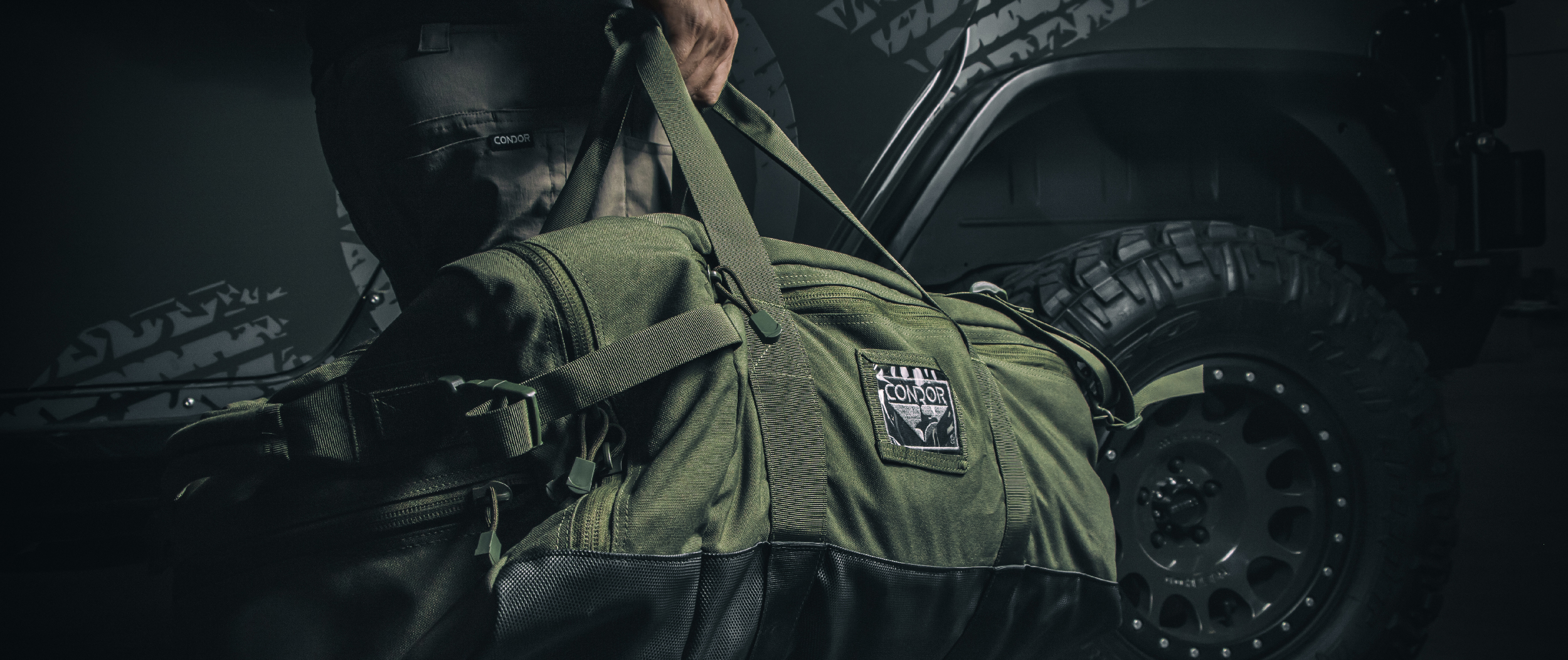 Image of someone holding the colossus duffel bag